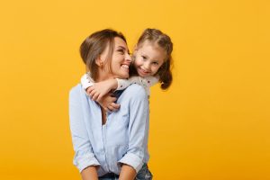 young mother and daughter smiling
