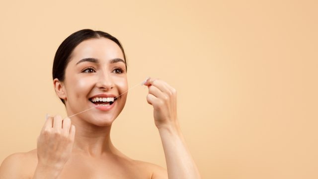 woman flossing her teeth