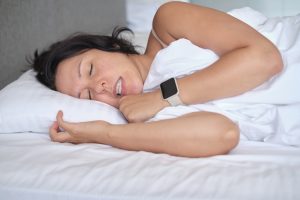 woman with bruxism, grinding her teeth in her sleep