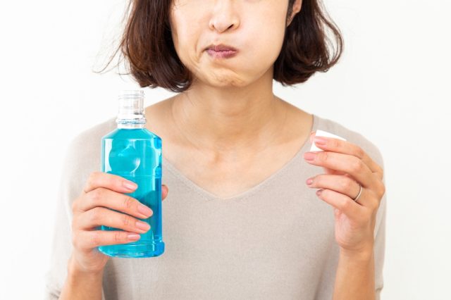 woman with mouthwash