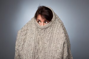 woman hiding in sweater